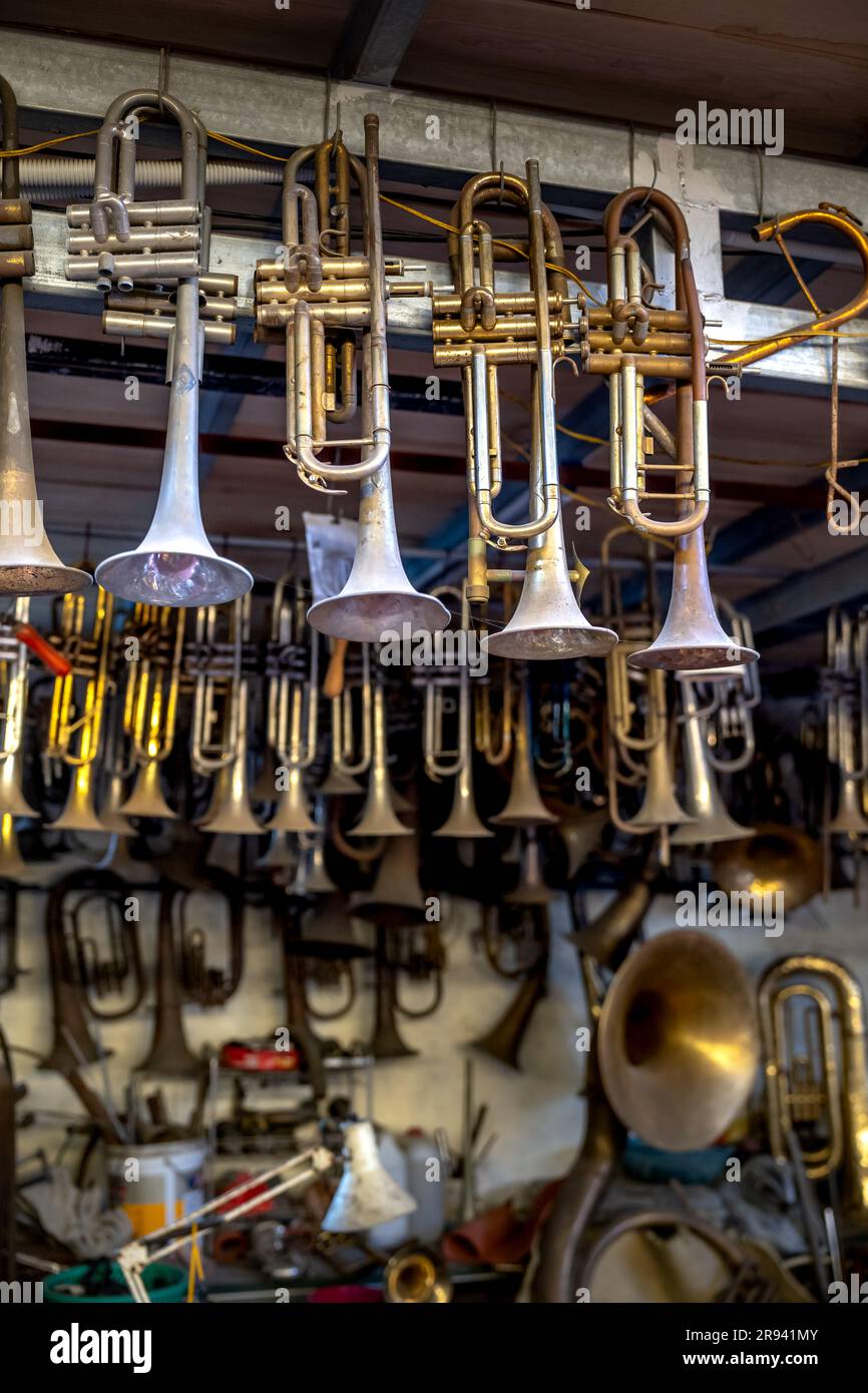 Damaged old brass trumpets waiting for repair Stock Photo