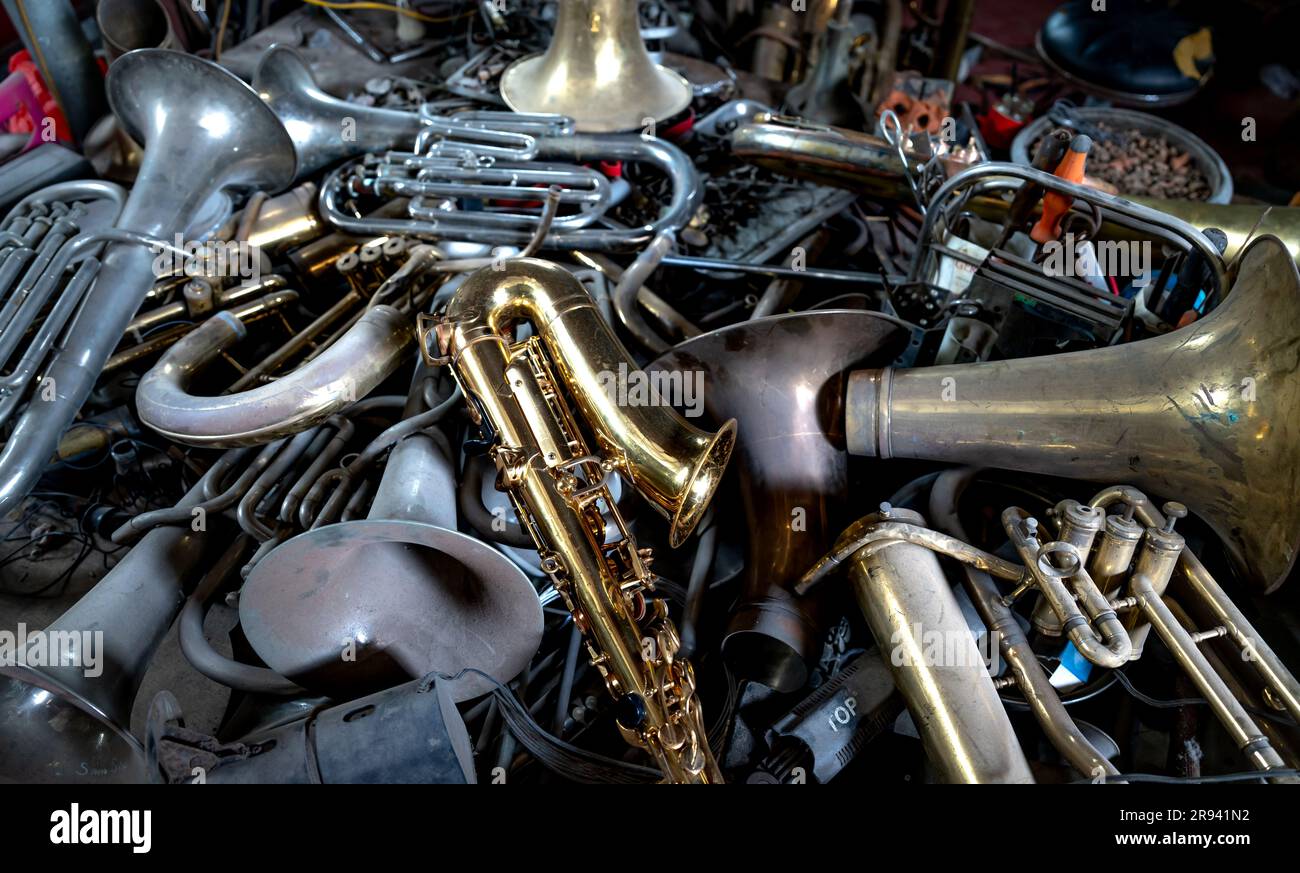 Damaged old brass trumpets waiting for repair Stock Photo