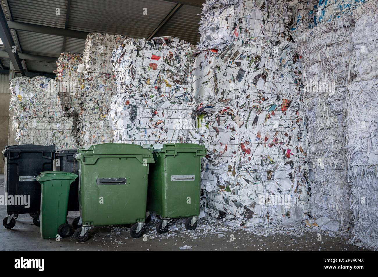 Stacked packages of shredded waste paper for recycling and garbage bin in Switzerland