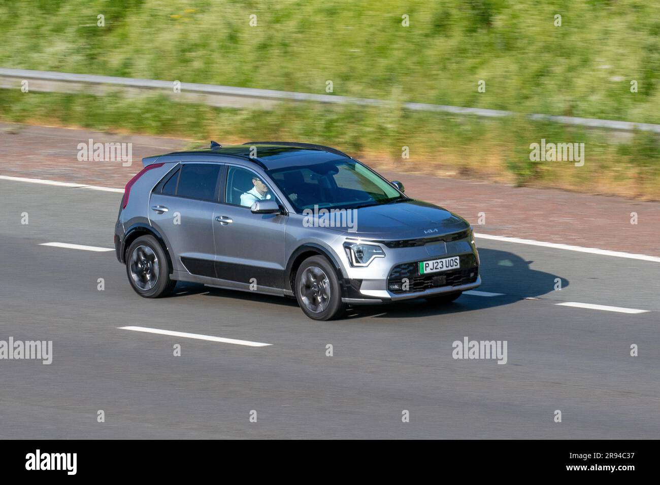 2023 Kia Niro 4 EV, 64.8-kWh battery pack ; travelling at speed on the M6 motorway in Greater Manchester, UK Stock Photo