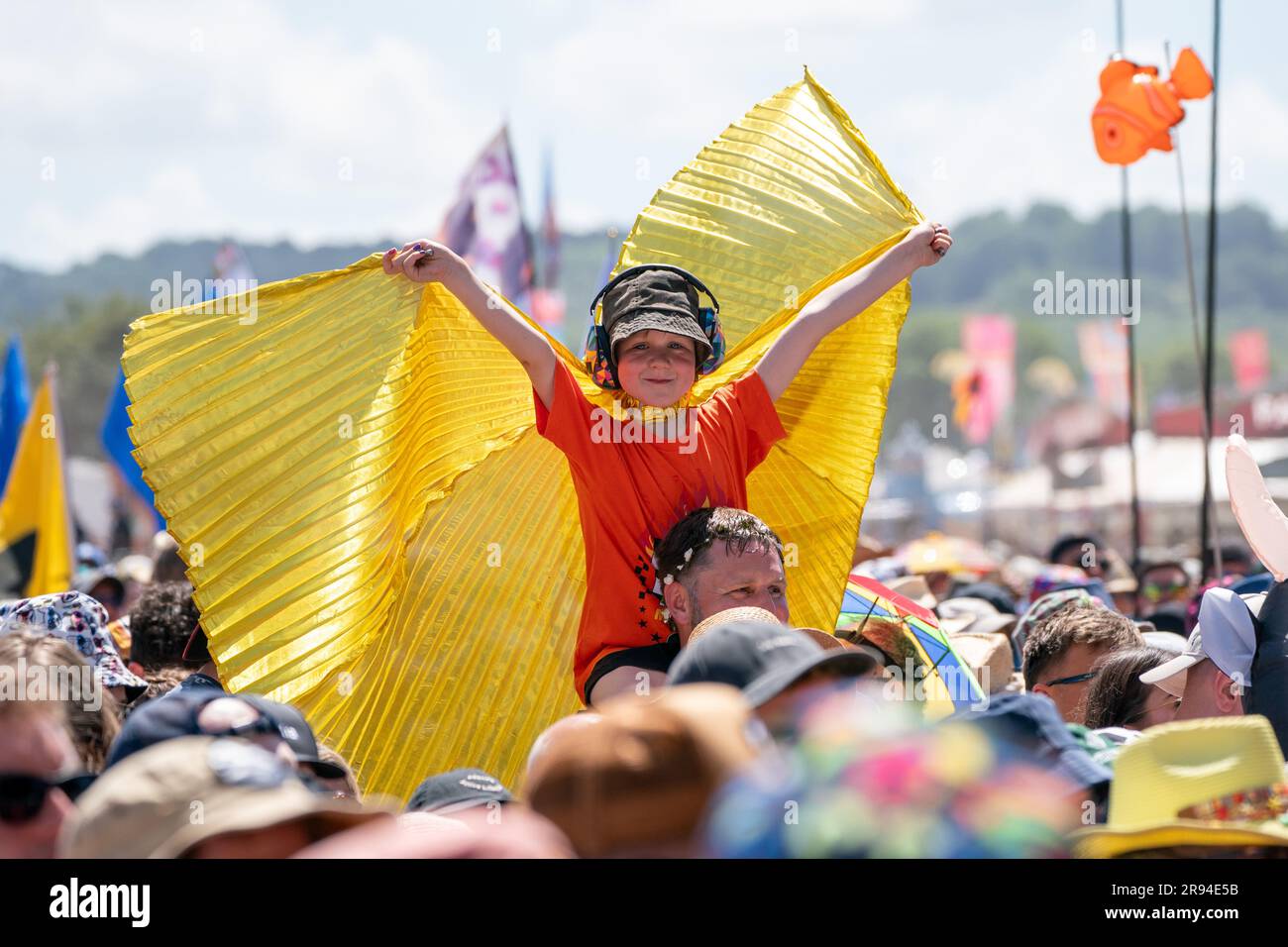 A boy wears wings the Glastonbury Festival at Worthy Farm in Somerset