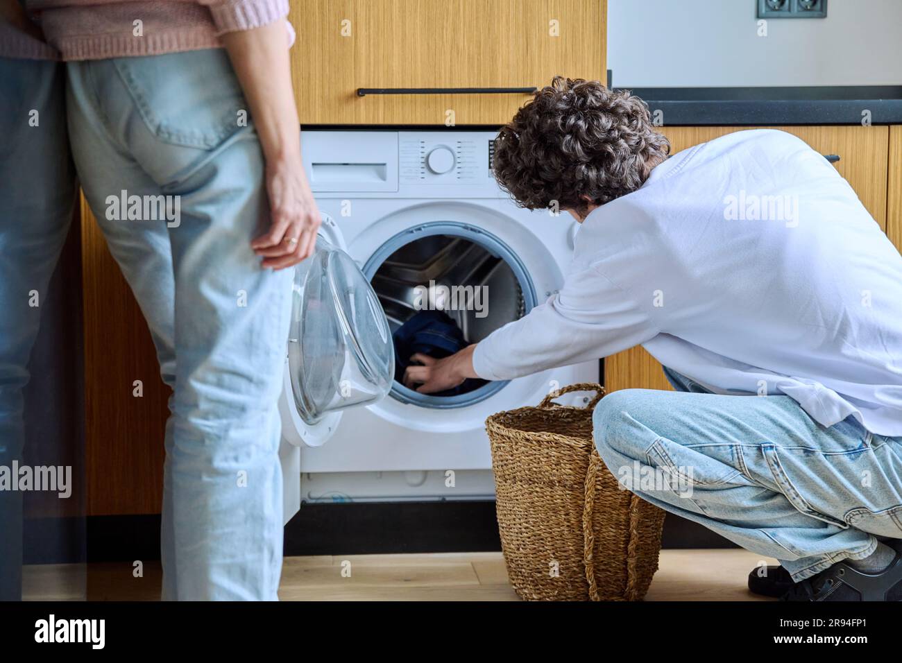 Woman using washing machine hi-res stock photography and images - Alamy