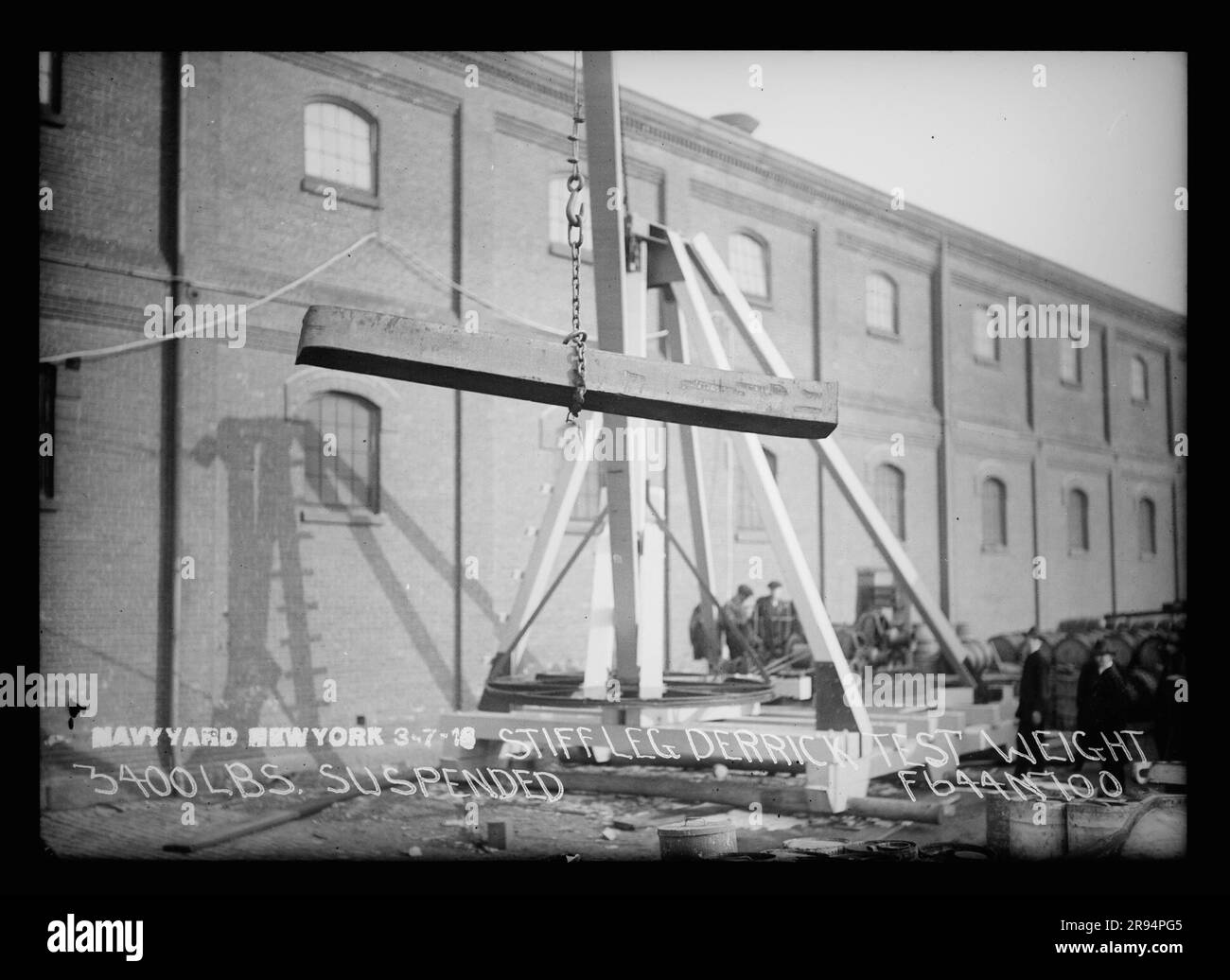 Stiff Leg Derrick, Test Weight, 3400 Pounds, Suspended. Glass Plate Negatives of the Construction and Repair of Buildings, Facilities, and Vessels at the New York Navy Yard. Stock Photo