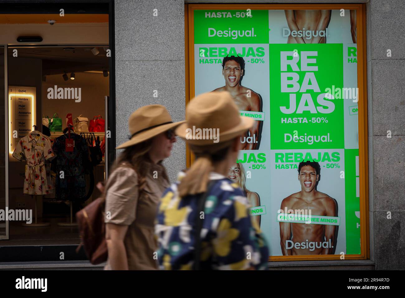 Madrid, Spain. 23rd June, 2023. Tourists walk past a Catalan chain Desigual  store with a "sale" sign on Calle Preciados in Madrid. On Friday, June 21,  the large stores and shops in