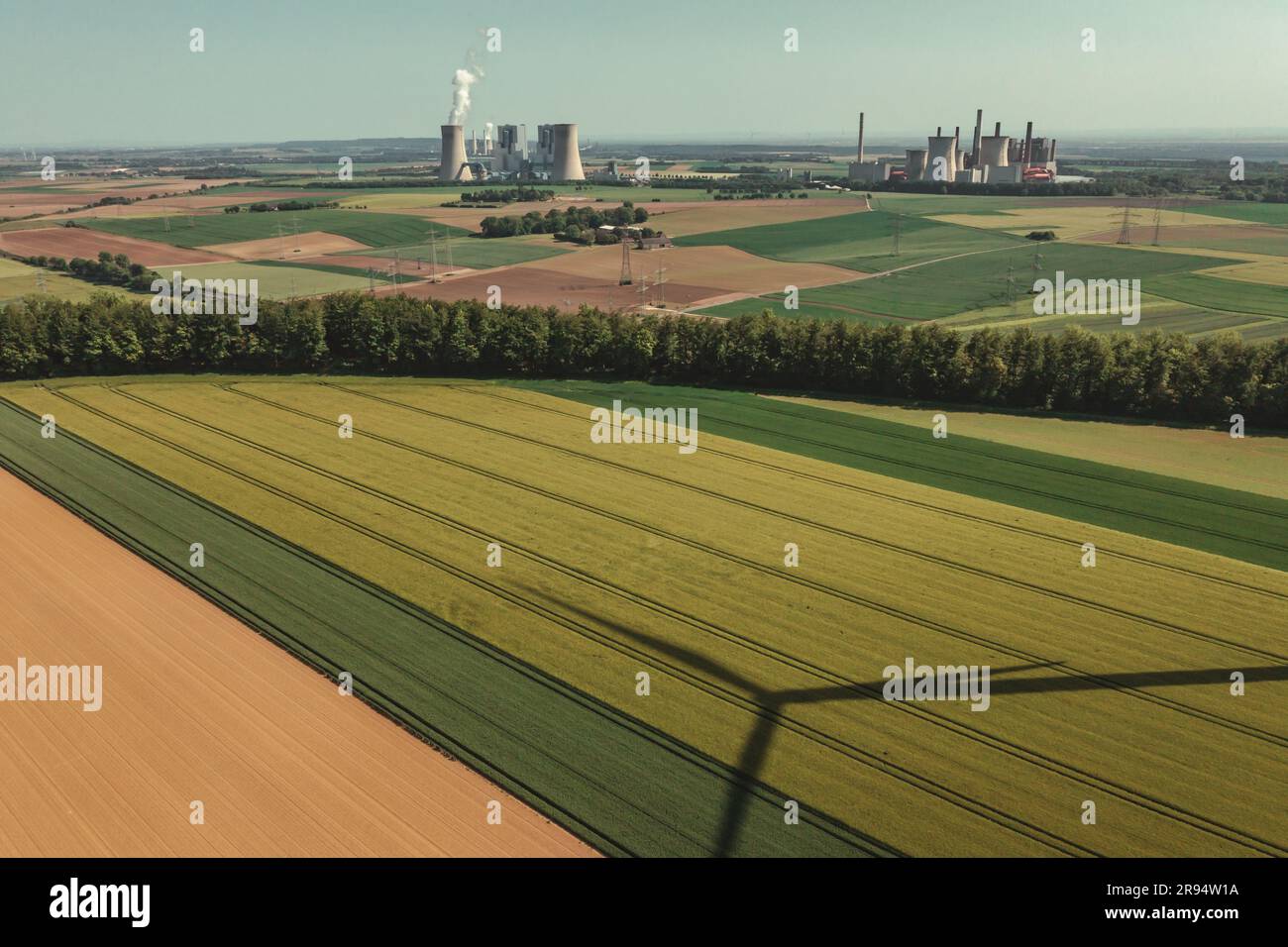 Drone view of the windmill shadow and the Neurath coal-fired power plant in the background in Grevenbroich Stock Photo