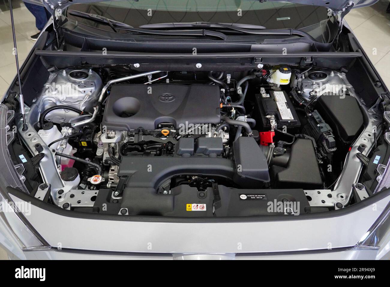 The internal mechanics of a car engine, with the hood open, revealing