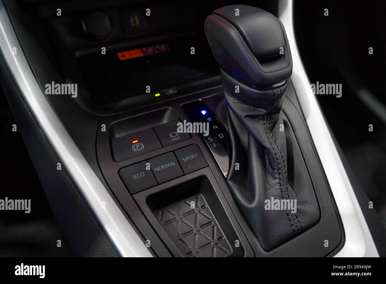 A gear knob in the dashboard of a car, indicating the ability to