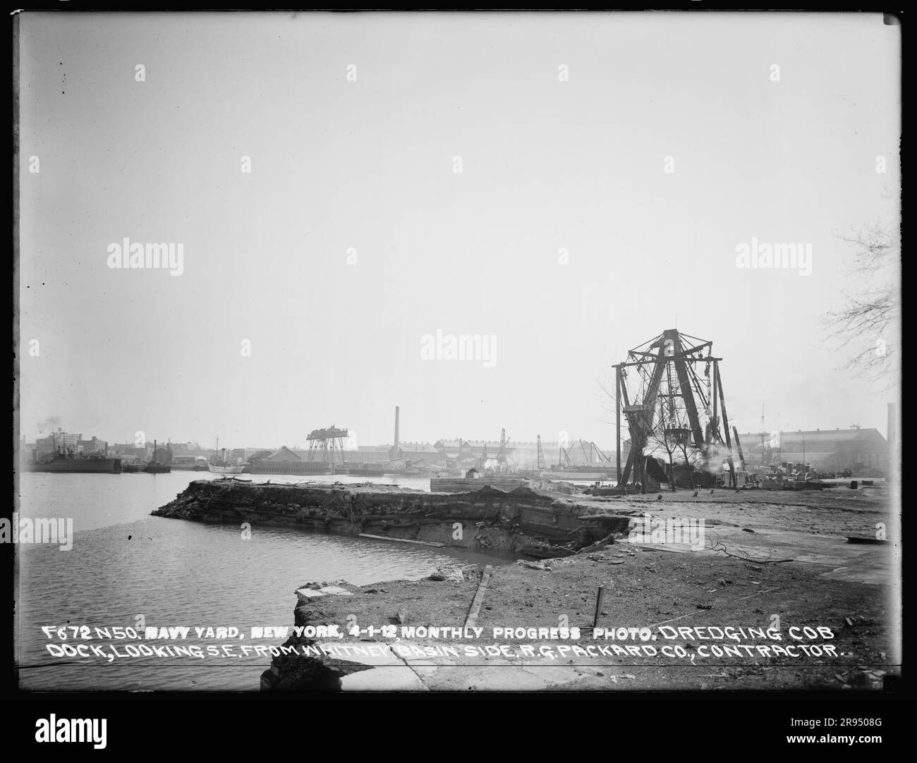 Monthly Progress Photo, Dredging Cob Dock, Looking Southeast from Whitney Basin Side, R. G. Packard Company, Contractor. Glass Plate Negatives of the Construction and Repair of Buildings, Facilities, and Vessels at the New York Navy Yard. Stock Photo