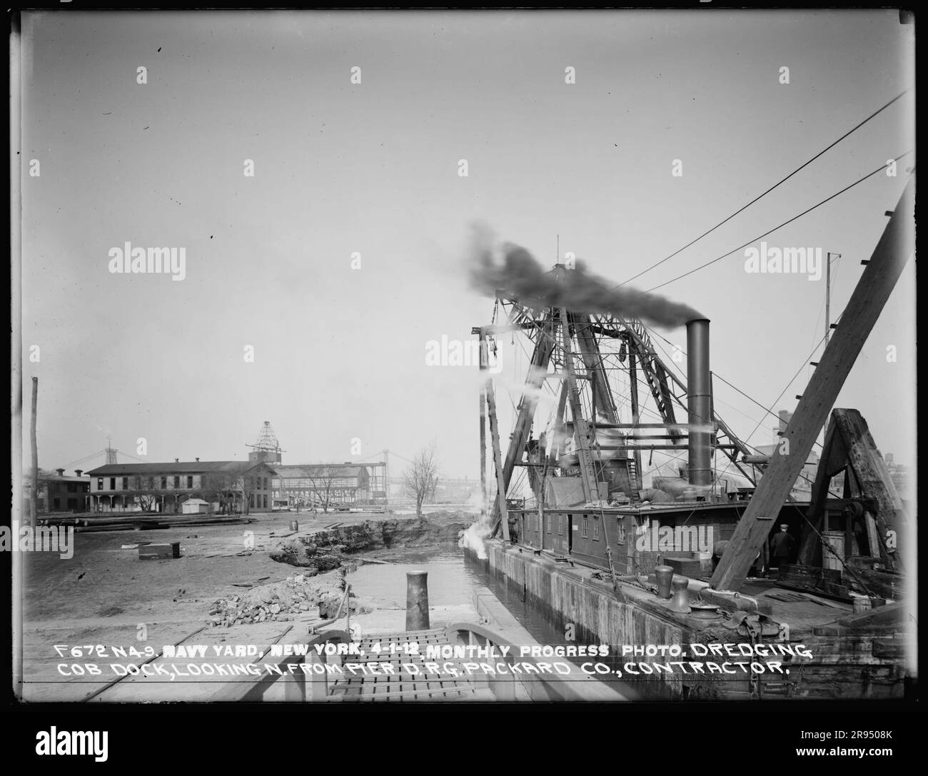 Monthly Progress Photo, Dredging Cob Dock, Looking North from Pier D, R. G. Packard Company, Contractor. Glass Plate Negatives of the Construction and Repair of Buildings, Facilities, and Vessels at the New York Navy Yard. Stock Photo