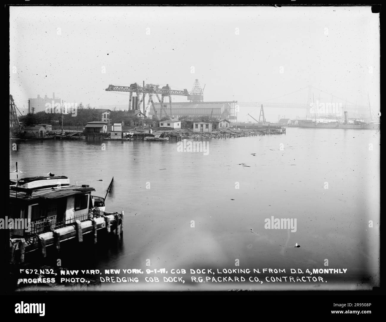 Cob Dock, Looking North from Dry Dock 4, Monthly Progress Photo, Dredging Cob Dock, R. G. Packard Company, Contractor. Glass Plate Negatives of the Construction and Repair of Buildings, Facilities, and Vessels at the New York Navy Yard. Stock Photo