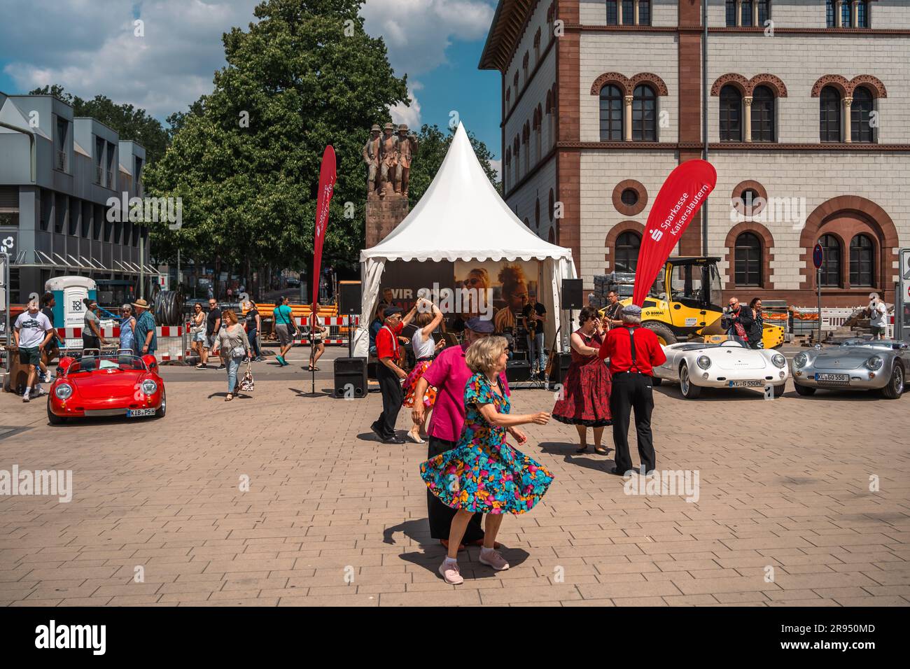 Kaiserslautern, Germany. 24th June, 2023. Couples dancing in the summer heat during live music performance at Schillerplatz (Square). The 15th Kaiserslautern Classics combines a vintage car show with the former ADAC Trifels Historic rallye (now under the new 'ADAC Trifels Oldtimerwanderung' name) and a Vespa meeting. The event starts on Saturday 8:30 AM and continues at various public locations downtown through the day, accompanied by live music bands. Credit: Gustav Zygmund/Alamy News Stock Photo