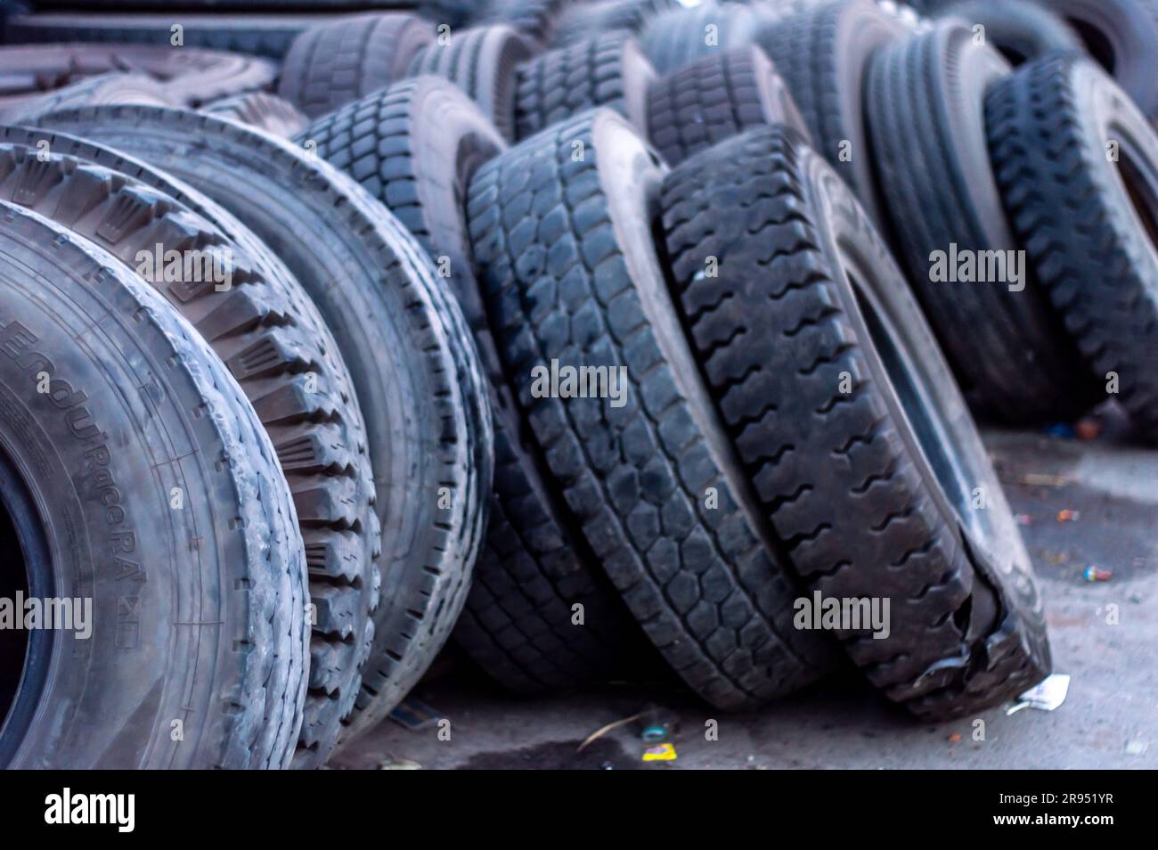 Used Tyres piled up and dumped in the roadside. Tires disposal Stock