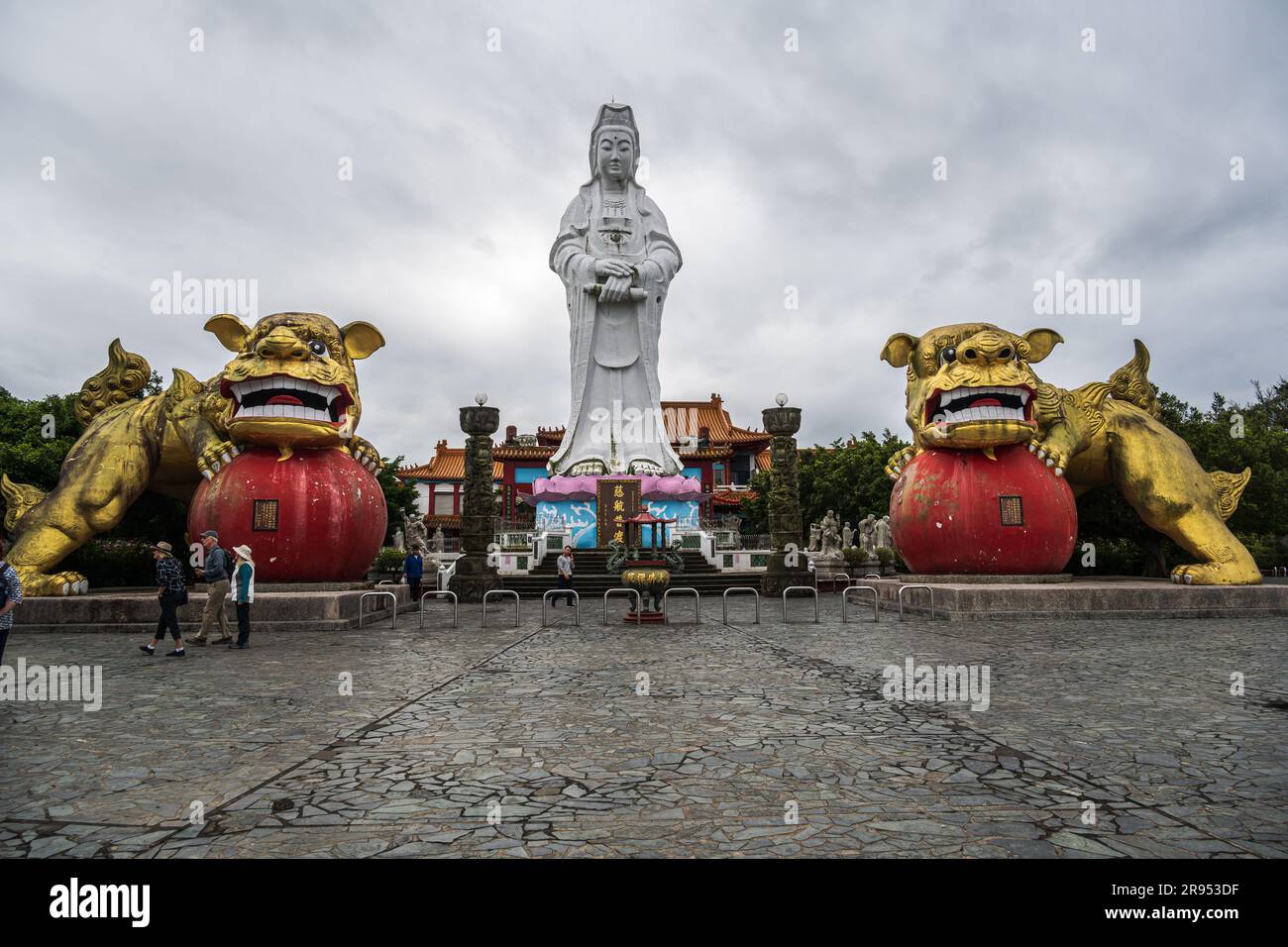 Keelung, Taiwan -- March 14, 2023. A wide angle photo of the Goddess Buddha flanked by golden lion statues at Zhongzheng Park Stock Photo