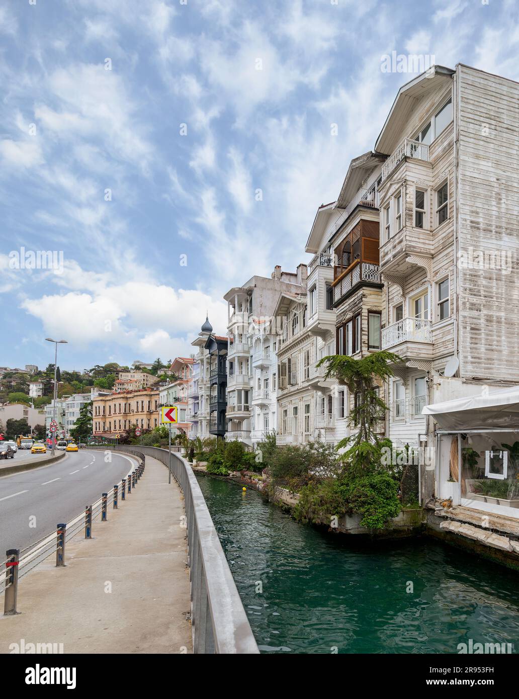 Wooden traditional residential buildings by a narrow water canal near Bosphorus strait, in Arnavutkoy neighborhood, Besiktas district, Istanbul, Turkiye, in a sunny spring day Stock Photo