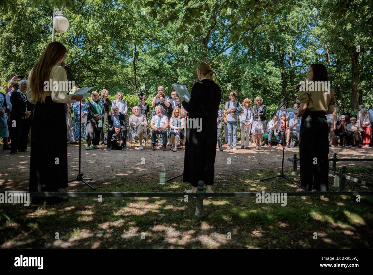 Berlin, Germany. 24th June, 2023. Actresses Greta Ipfelkofer (l-r), Lisa Altenpohl and Varya Popovkina, read at the memorial hour marking the 90th anniversary of the ban on the Jehovah's Witnesses faith community at the Goldfish Pond in Tiergarten. According to a motion of the traffic light coalition in the Bundestag, a memorial for the Jehovah's Witnesses persecuted and murdered by the Nazi regime is to be built in Berlin's Tiergarten. Credit: Carsten Koall/dpa/Alamy Live News Stock Photo