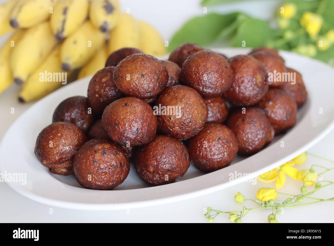 Unniyappam. Sweet rice fritters made with a batter of rice, banana, jaggery, ghee fried coconut