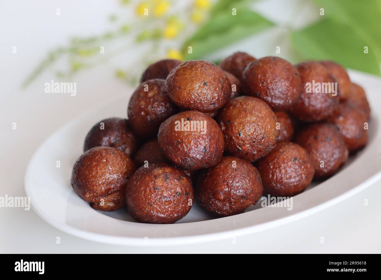 Unniyappam. Sweet rice fritters made with a batter of rice, banana, jaggery, ghee fried coconut