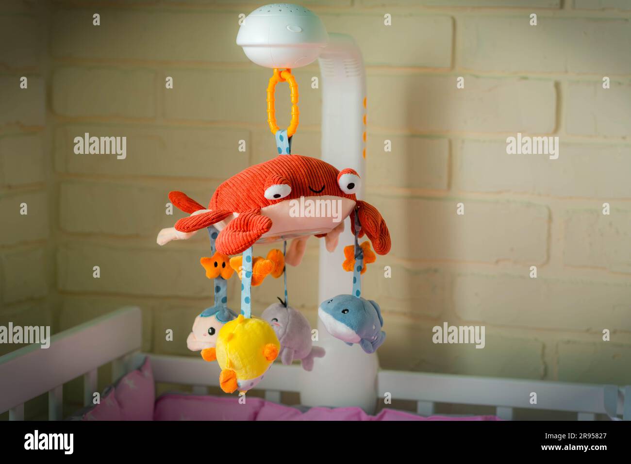 Mobile with soft toys in the crib. Mobile for baby. Children's Toy Red