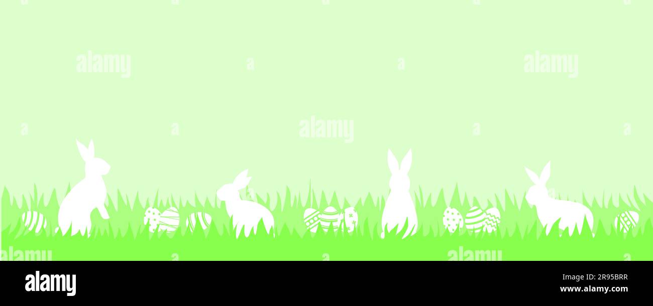 White rabbits and Easter eggs in green grass on a light green ...