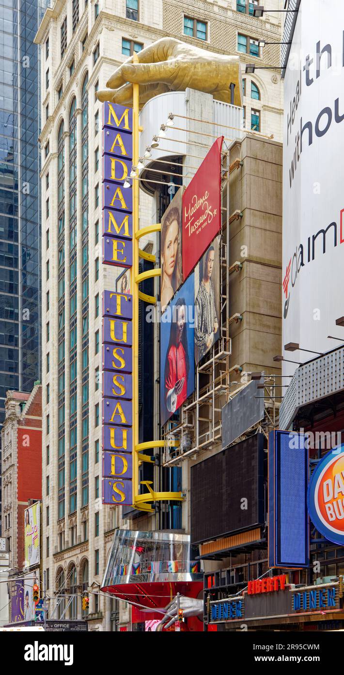 A giant hand marks Madame Tussaud’s 42nd Street wax museum, which shares its address with AMC Empire Theater and now-closed Hilton Times Square hotel. Stock Photo