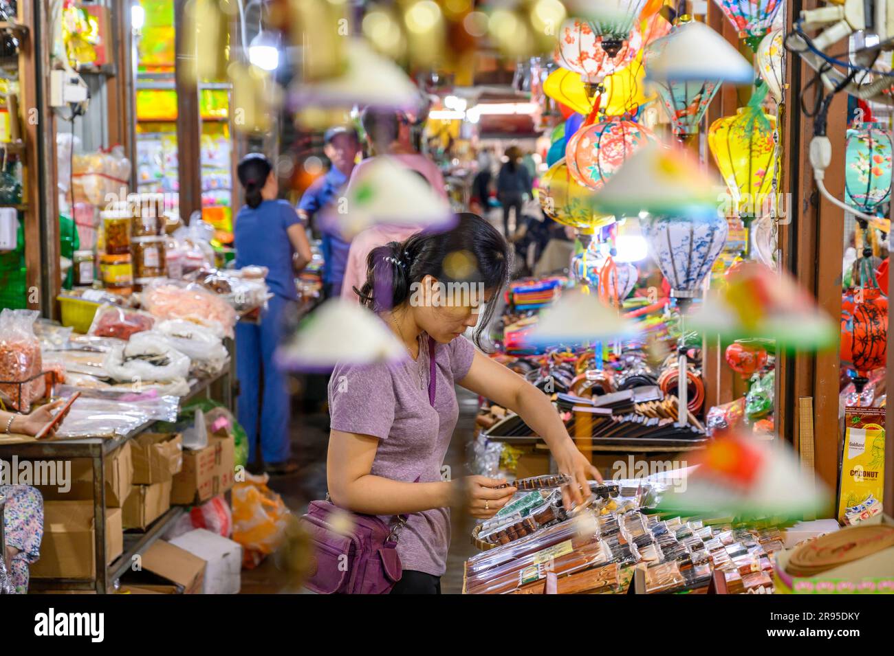 A female vendor tends to her crafts stall in Hoi An Market in old town Hoi An, Vietnam. Stock Photo