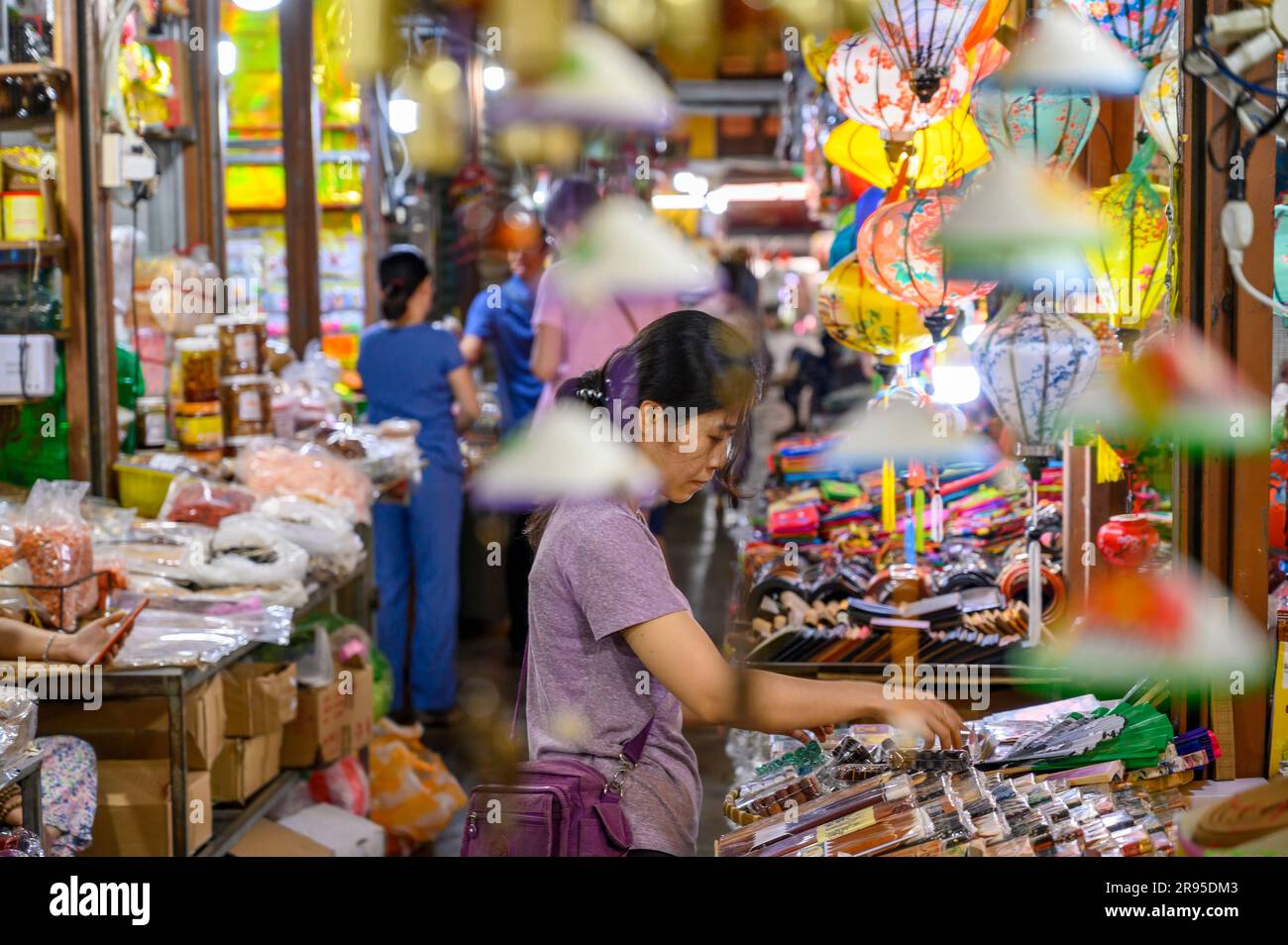A female vendor tends to her crafts stall in Hoi An Market in old town Hoi An, Vietnam. Stock Photo