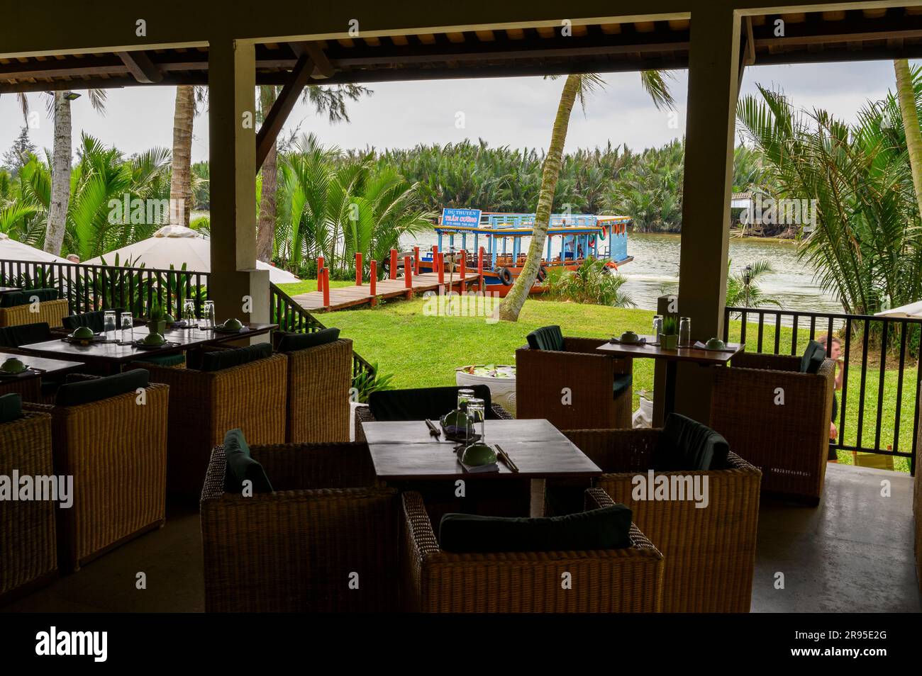 View to the Thu Bon river from the open front restaurant part of the Red Bridge Cooking School on the outskirts of Hoi An, Vietnam. Stock Photo