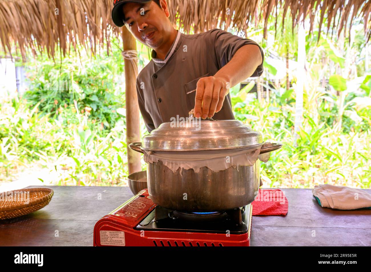 Chef and tutor demonstrates how to cook rice paper used for rolls and