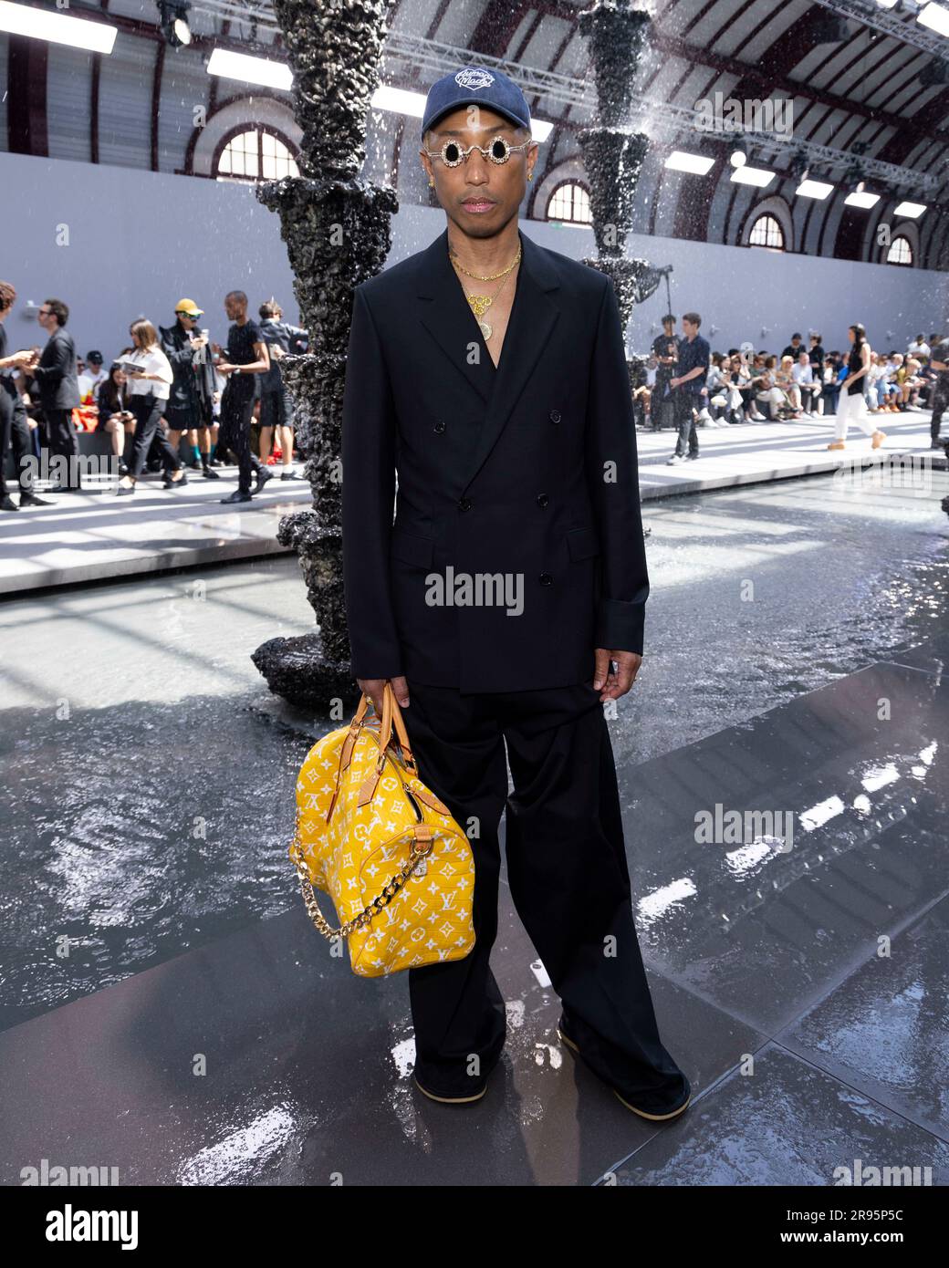 Pharrell Williams Wears Boot Pants at Loewe's Spring 2024 Men's Show –  Footwear News