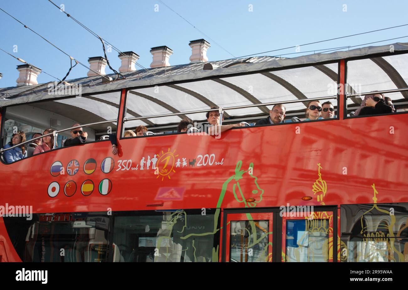 Observation bus in the city against a background of old building roof Stock Photo