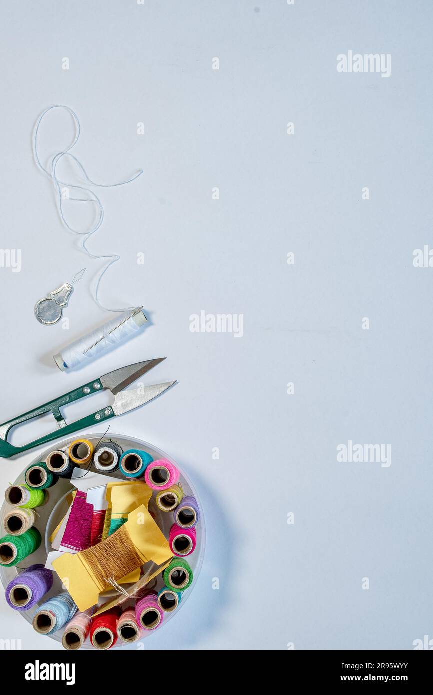 A bundle of various color thread spools of the sewing machine with a ...