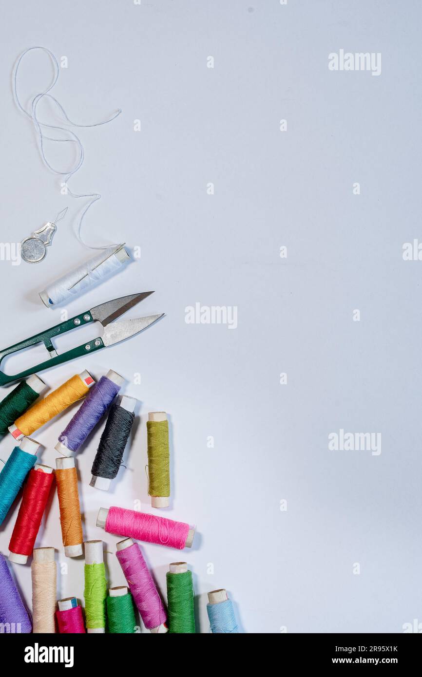 A bundle of various color thread spools from the sewing machine with a ...