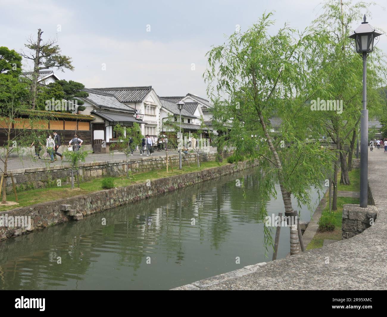 Kurashiki: one of the most picturesque towns in Japan with its white houses in the old merchant quarter and tree-lined canal with stone bridges. Stock Photo