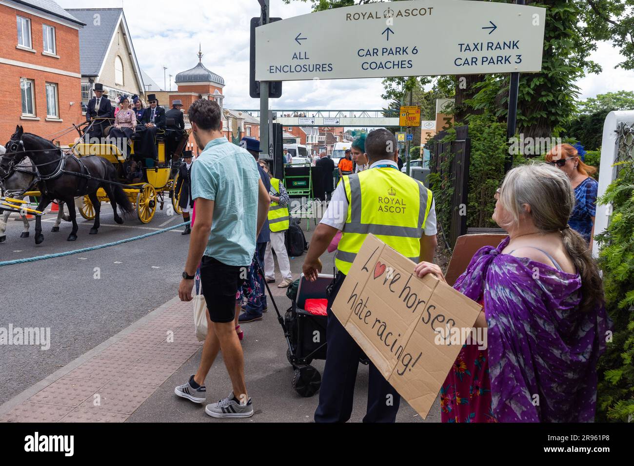 Ascot, UK. 24th June, 2023. Racegoers on a horse-drawn carriage pass an animal rights campaigner as they arrive for the fifth day of Royal Ascot. 28 horses died in jumps and flat races at Ascot between 2012-2022. Credit: Mark Kerrison/Alamy Live News Stock Photo