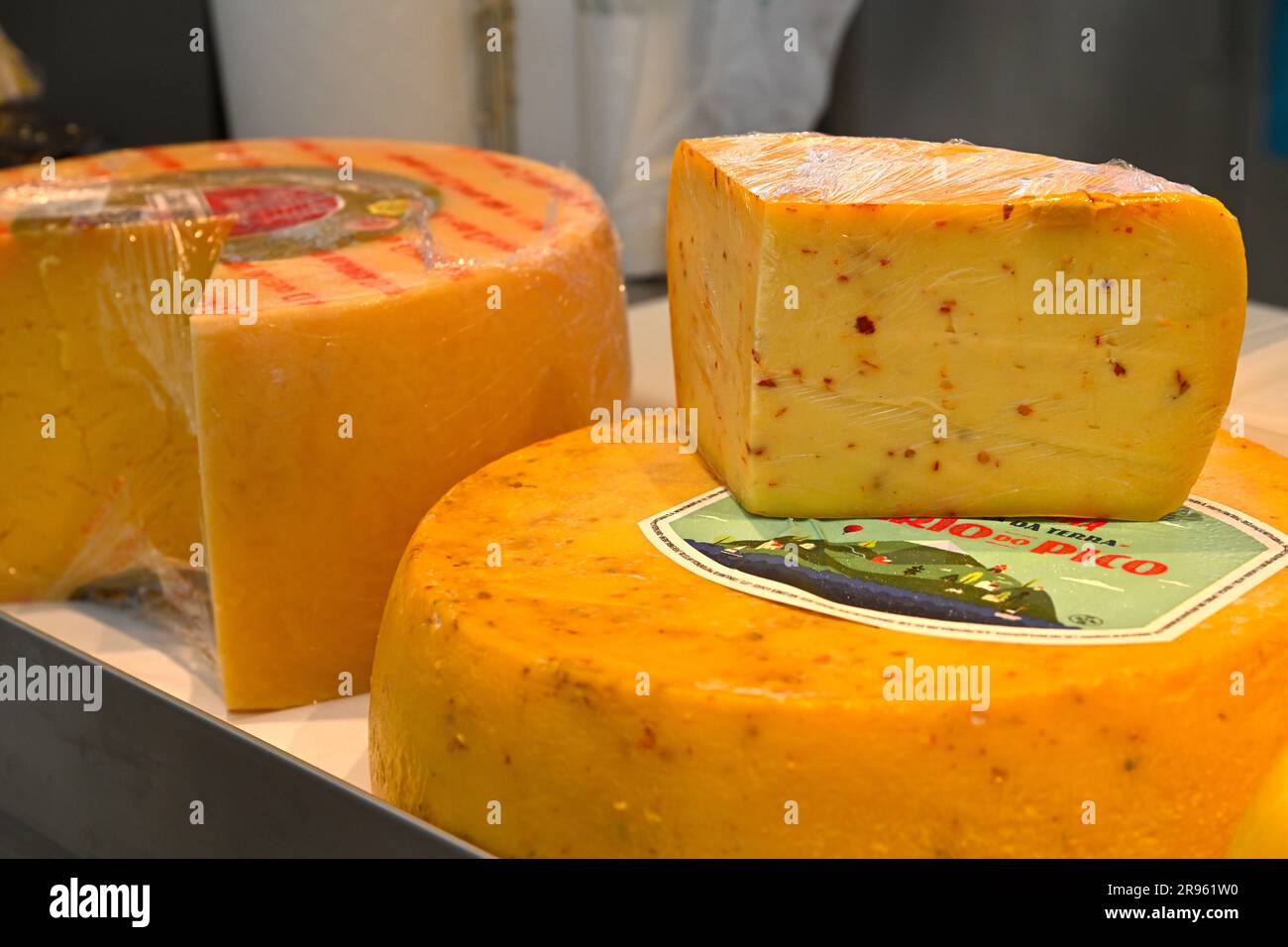 Cheese wheels and wedge segment our of a cheese Stock Photo - Alamy