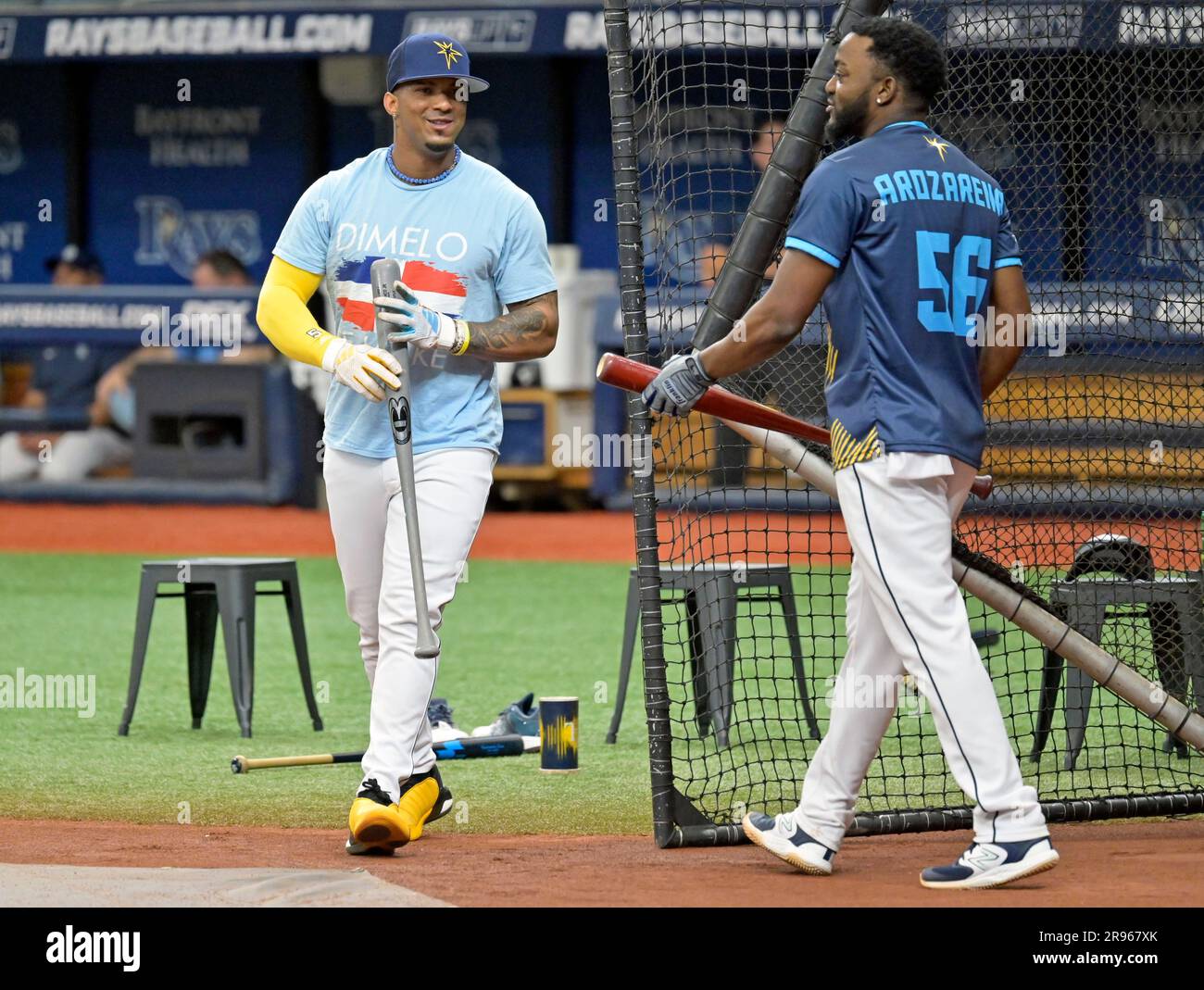 Tampa Bay Rays' Wander Franco, left, and Vidal Brujan, wearing a Arozarena  promotional give-away jerseys, switch places during batting practice before  a baseball game against the Kansas City Royals Saturday, June 24,