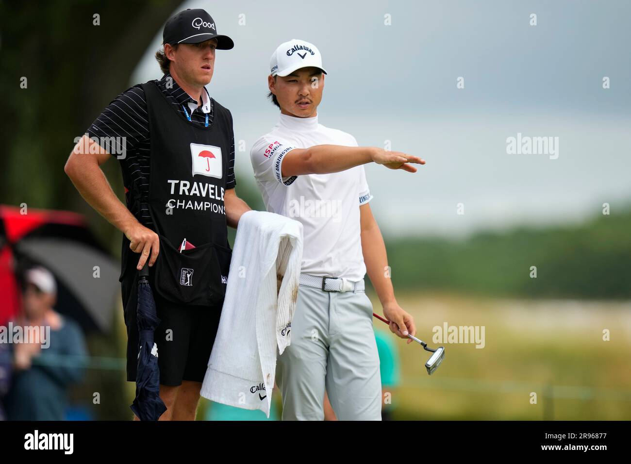 Australias Min Woo Lee, right, talks with his caddie on the fourth hole during the third round of the Travelers Championship golf tournament at TPC River Highlands, Saturday, June 24, 2023, in