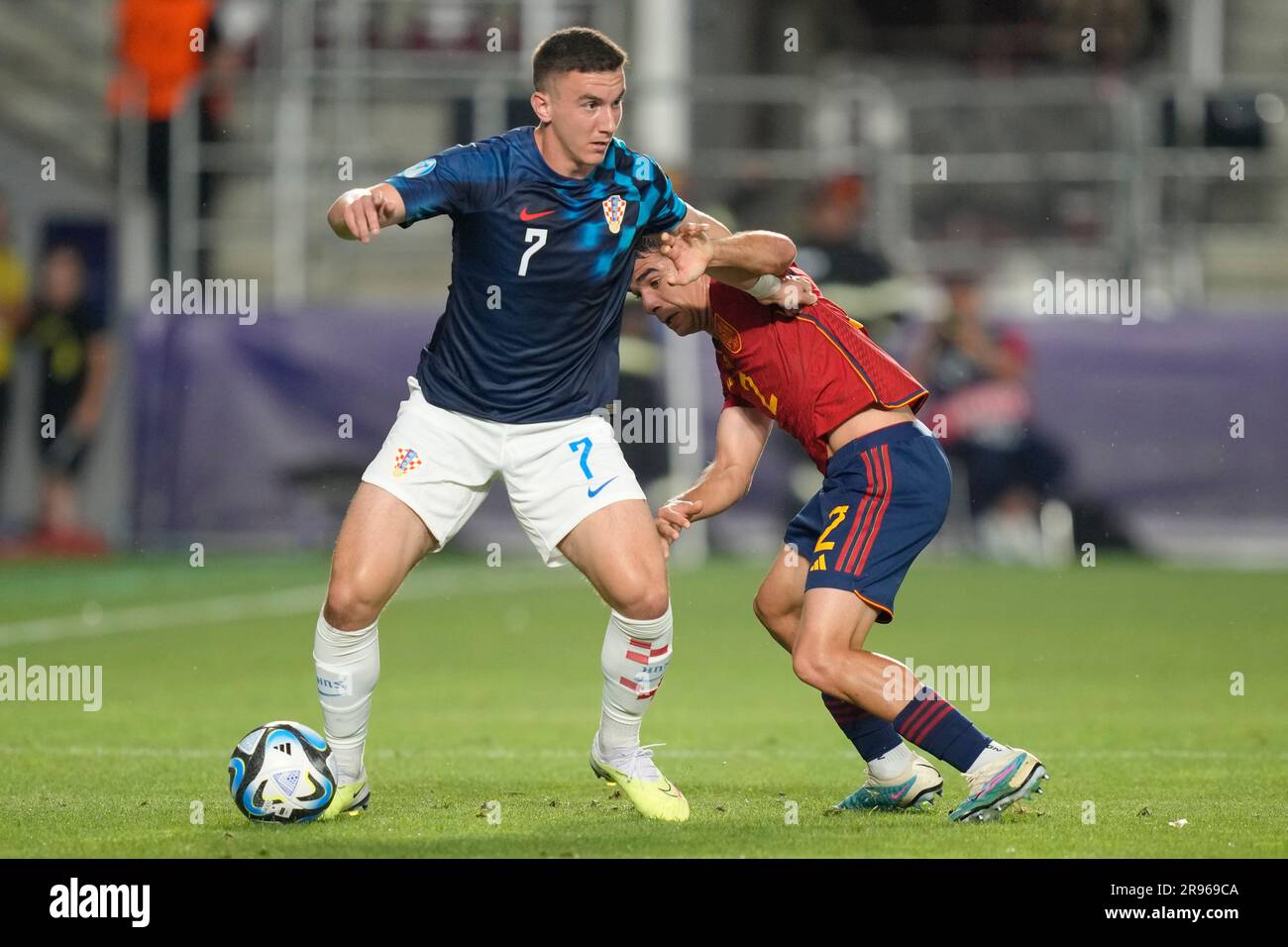 Victor Gomez of Spain right challenges for the ball with