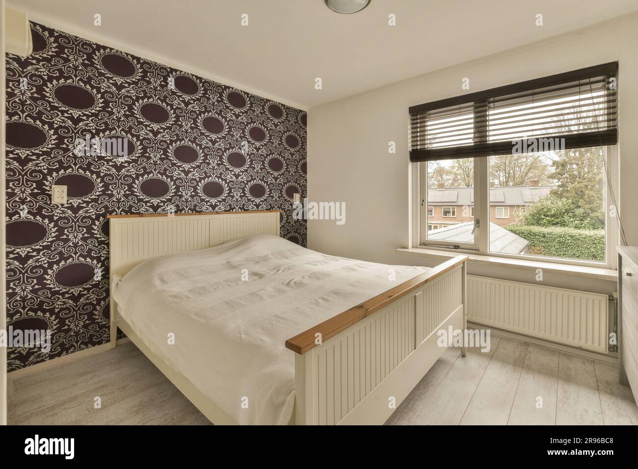 a bedroom with purple and white wallpaper on the walls, along with a