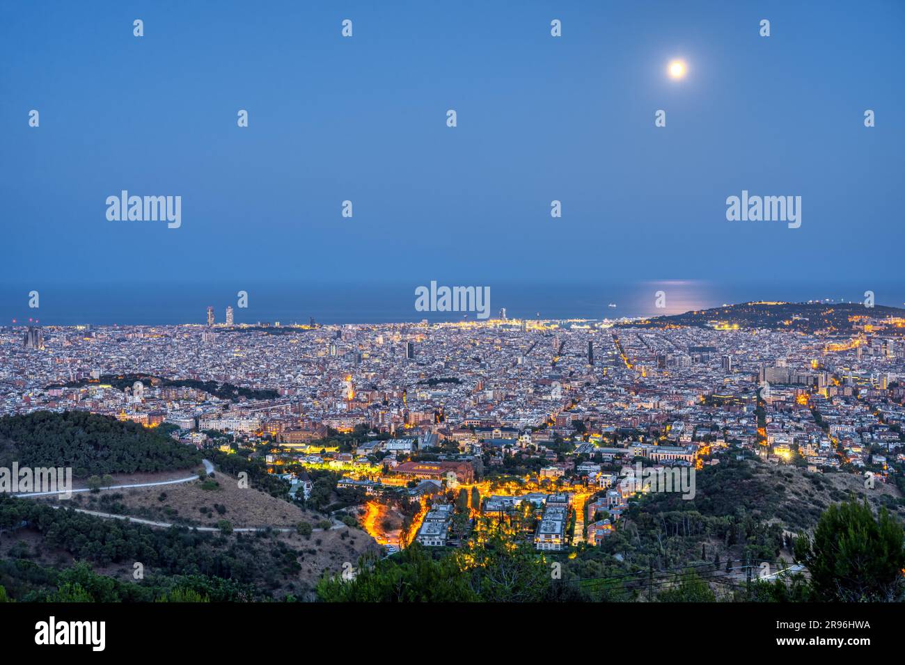 Night view of Barcelona from the Collserola mountain range under a full moon Stock Photo