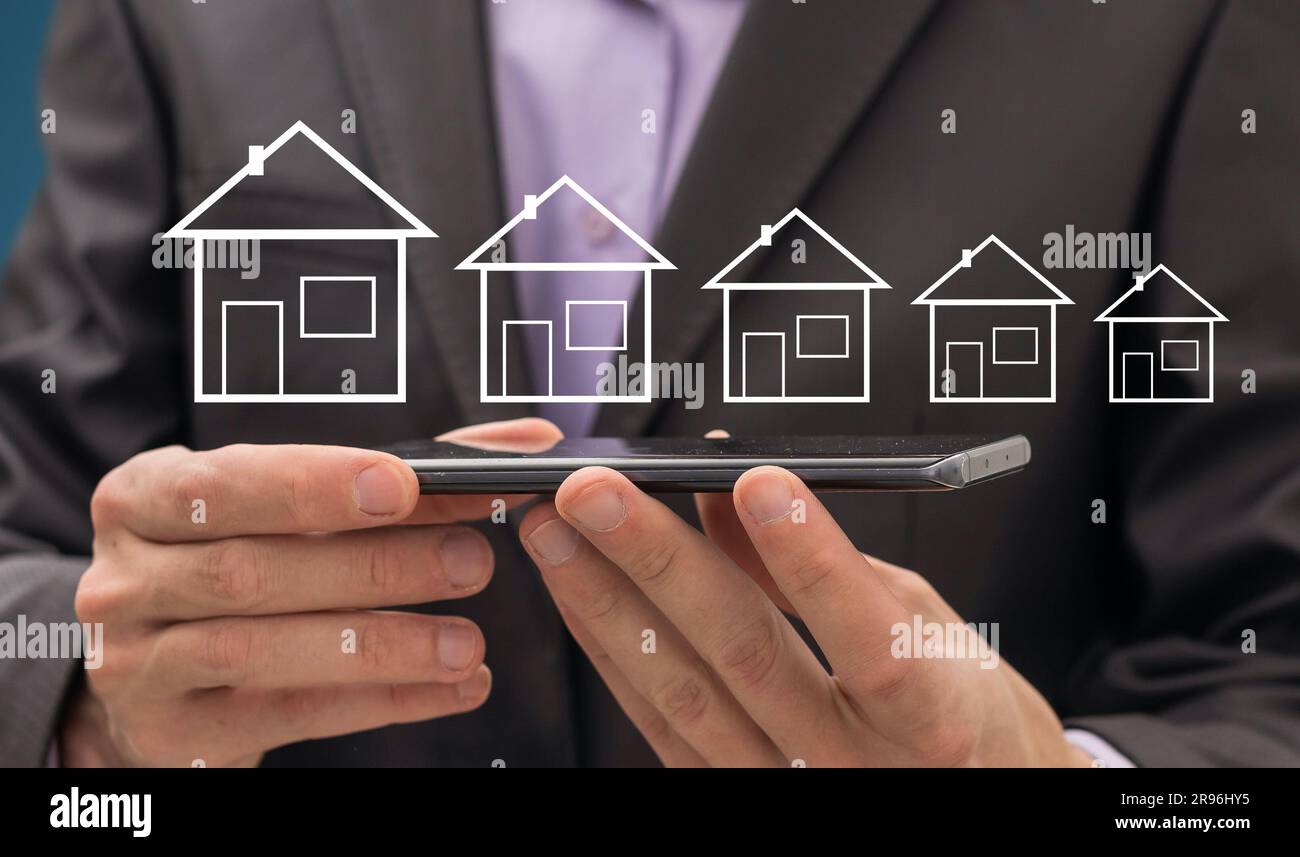 Business man hand house model in screen Stock Photo - Alamy
