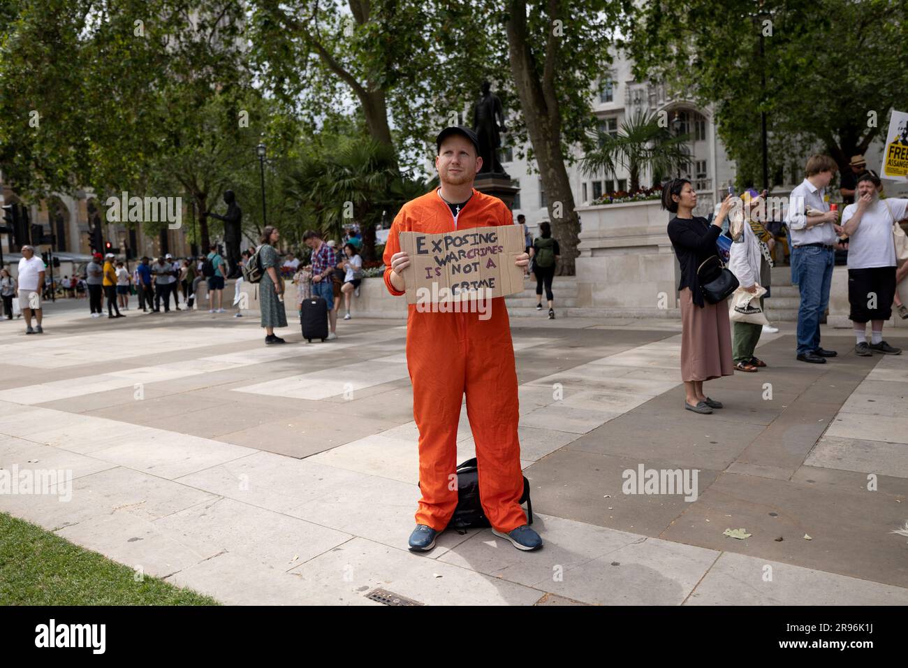 London, UK. 24th June, 2023. A supporter is seen wearing a prisoner costume and holding a placard in solidarity with Julian Assange during the demonstration. Supporters of Julian Assange, an Australian editor who found WikiLeak, protest to urge the UK government to release him from Belmarsh Prison and stop extraditing him to the US. Credit: SOPA Images Limited/Alamy Live News Stock Photo