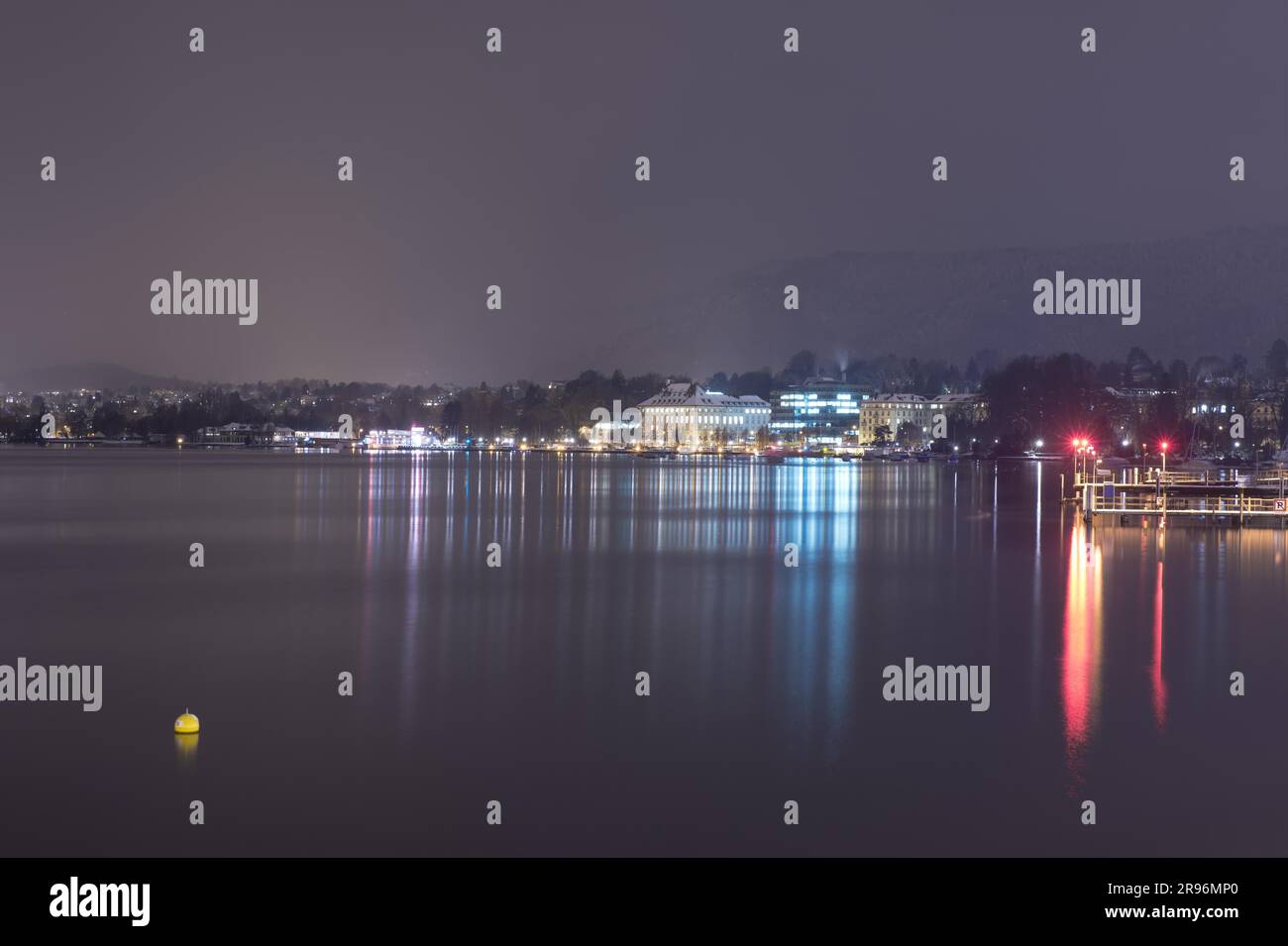 Cityscape at Night with Lake Zurich and Mountain in Switzerland Stock Photo