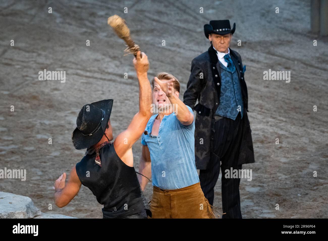 Bad Segeberg, Germany. 24th June, 2023. Bastian Semm as Old Shatterhand (l-r) fights with an extra while Wolfgang Bahro as Santer watches in the background in the premiere 'Winnetou I - Blood Brothers' of the 70th season of the Karl May Games in Bad Segeberg. Since 1952, Karl May's adventure novels have been brought to the stage in Bad Segeberg's Kalkberg Stadium - this year it's 'Winnetou I: Blood Brothers'. Credit: Jonas Walzberg/dpa/Alamy Live News Stock Photo