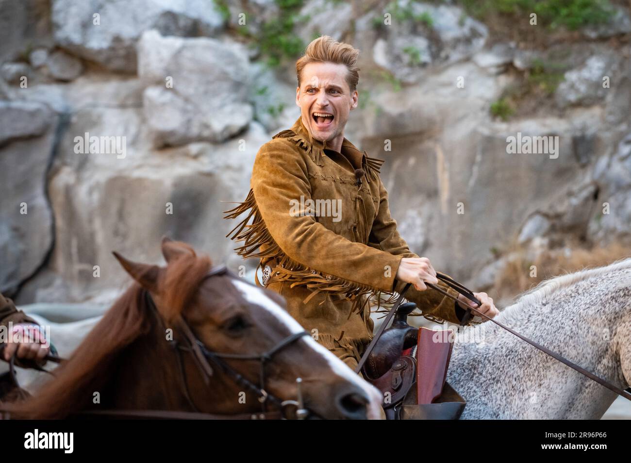 Bad Segeberg, Germany. 24th June, 2023. Bastian Semm as Old Shatterhand rides a horse during the premiere 'Winnetou I - Blood Brothers' of the 70th season of the Karl May Games in Bad Segeberg. Since 1952, Karl May's adventure novels have been brought to the stage in Bad Segeberg's Kalkberg Stadium - this year it's 'Winnetou I: Blood Brothers'. Credit: Jonas Walzberg/dpa/Alamy Live News Stock Photo
