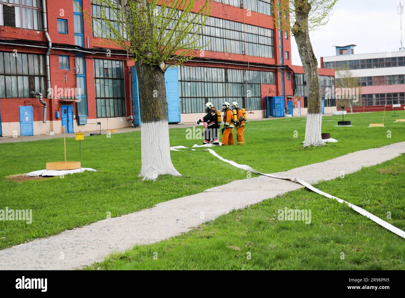 Professional firefighters, rescuers in protective fireproof suits