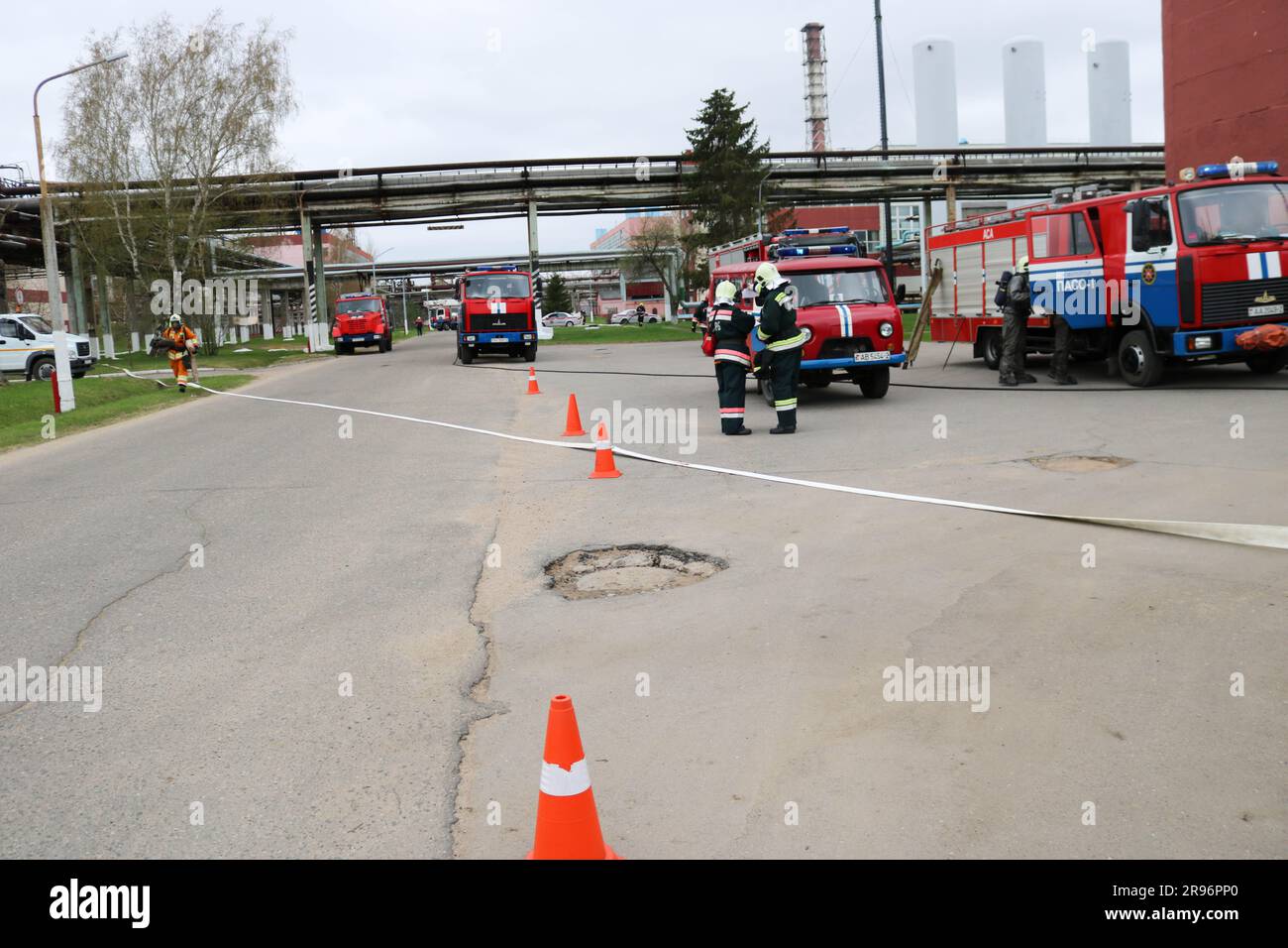 A large red fire rescue vehicle, a truck to extinguish a fire and male ...
