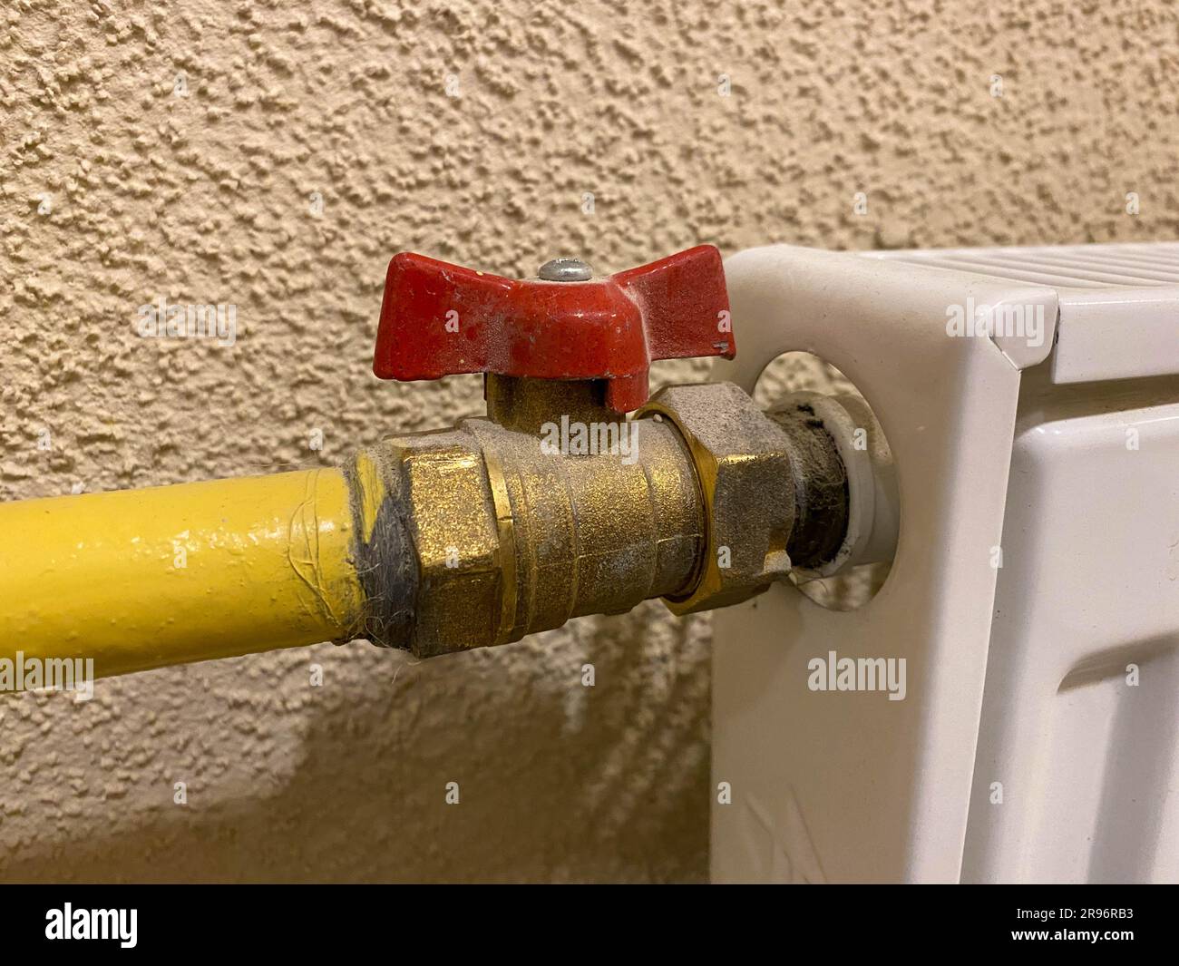 Small iron red industrial shutoff and control valves, plumbing ball