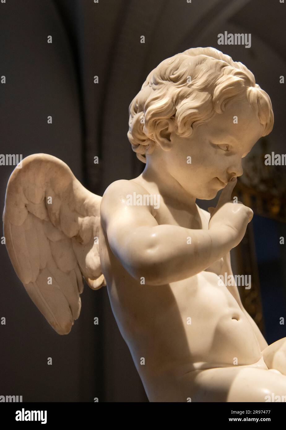 Angel or cupid at the Rijsmuseum in Amsterdam looking like it says, 'Be Quiet.' Stock Photo