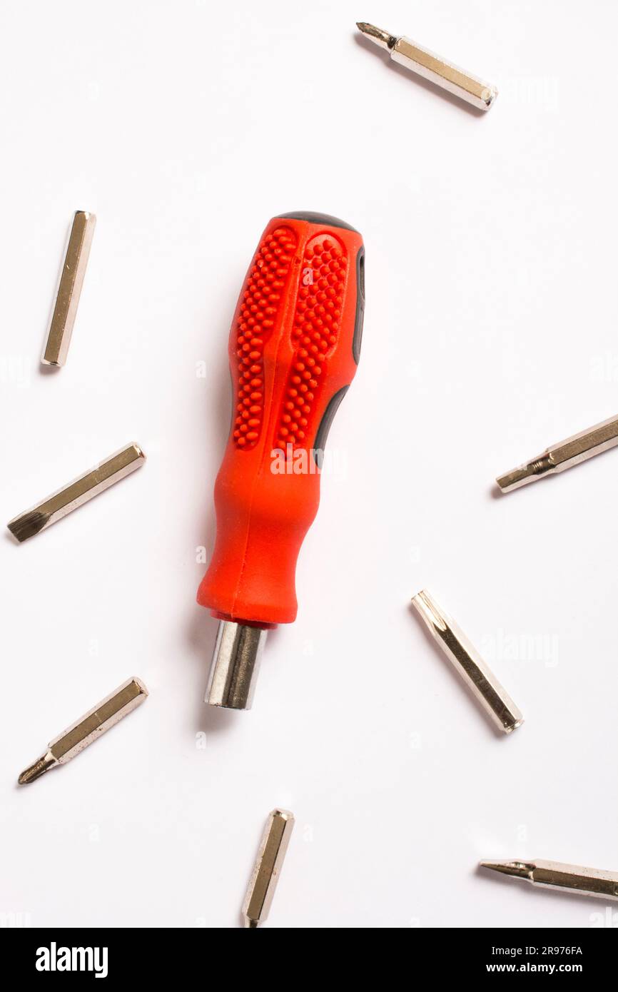 red screwdriver, white background and bits, spare parts Stock Photo Alamy
